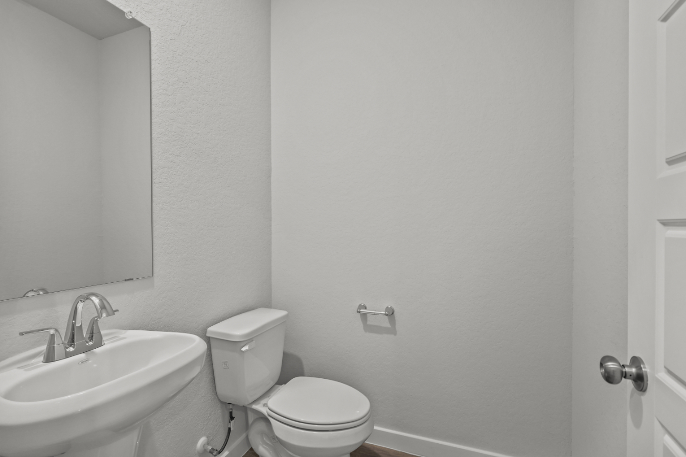 A bathroom with a toilet and sink.