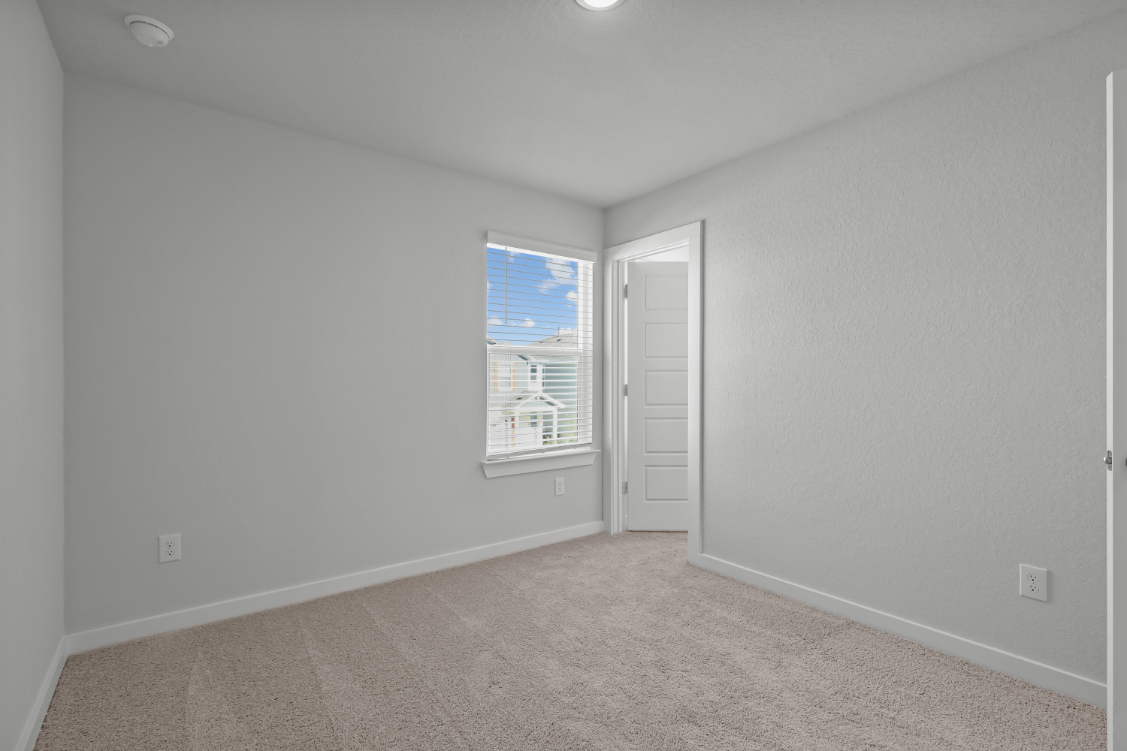 A room with a window and a door.