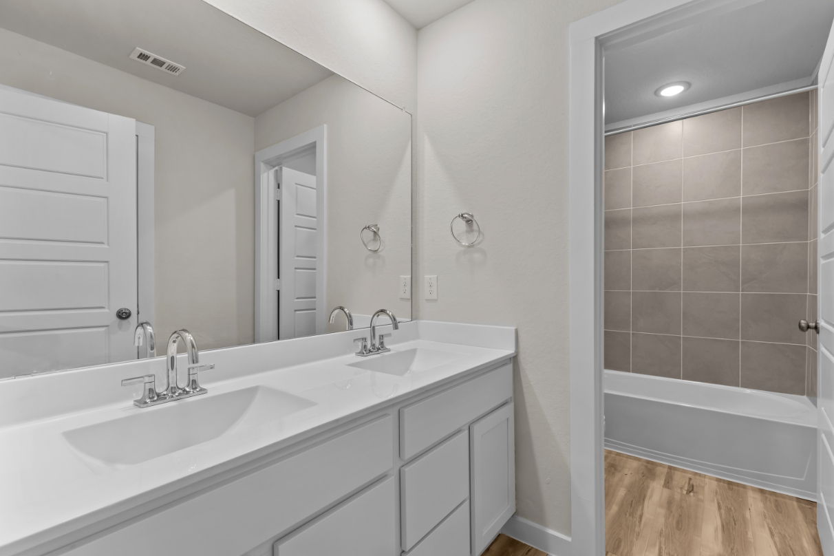 A bathroom with a tub sink and a shower.