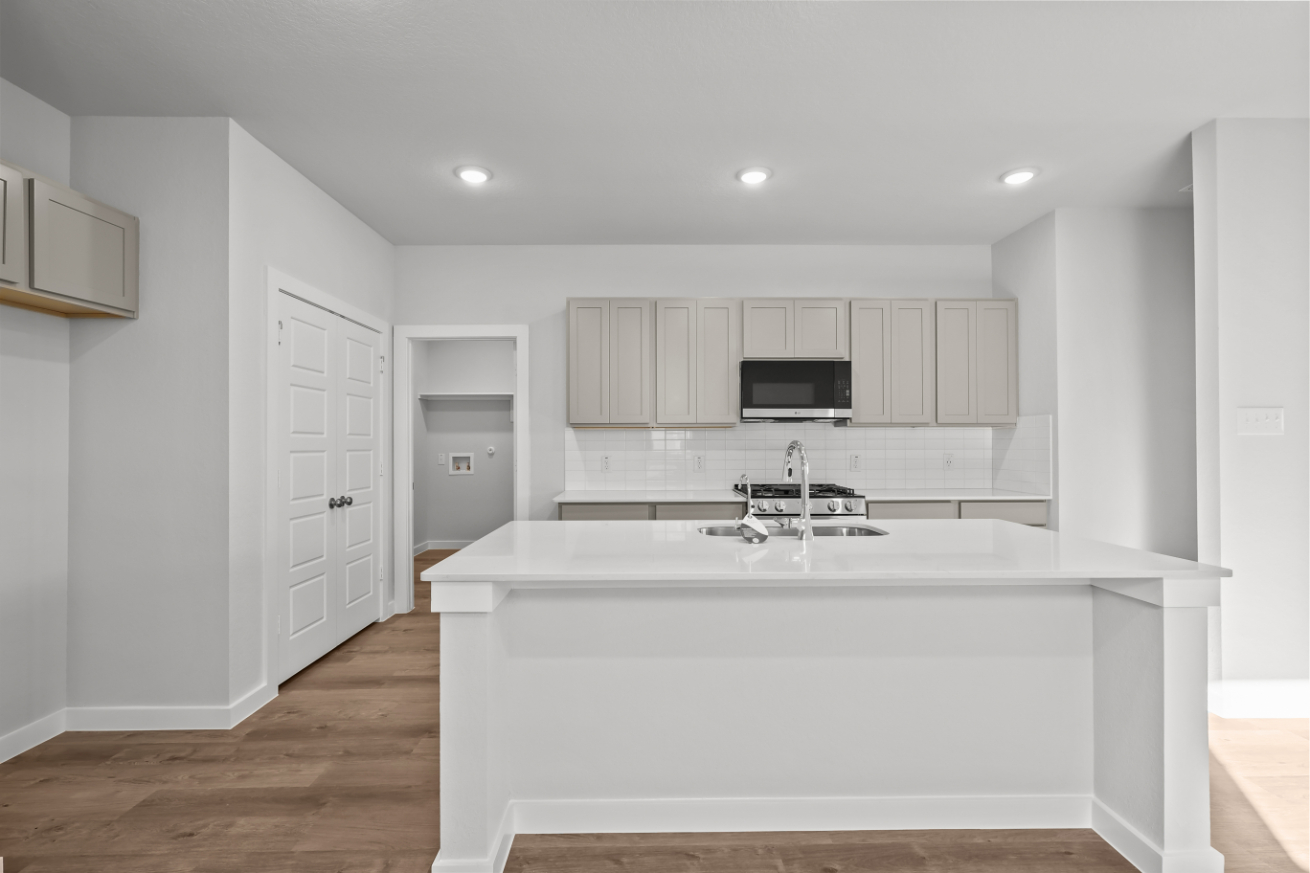 A kitchen with white cabinets.