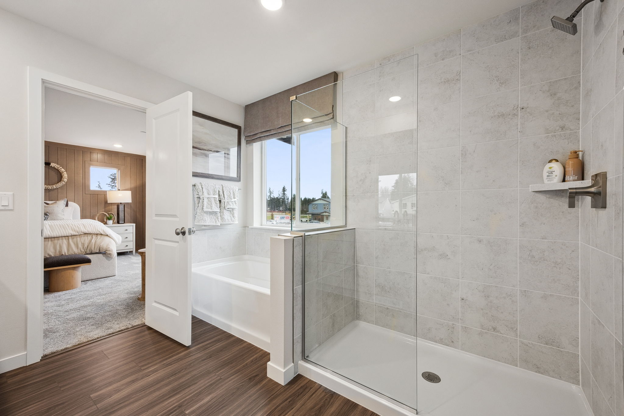 A bathroom with a tub and a mirror.