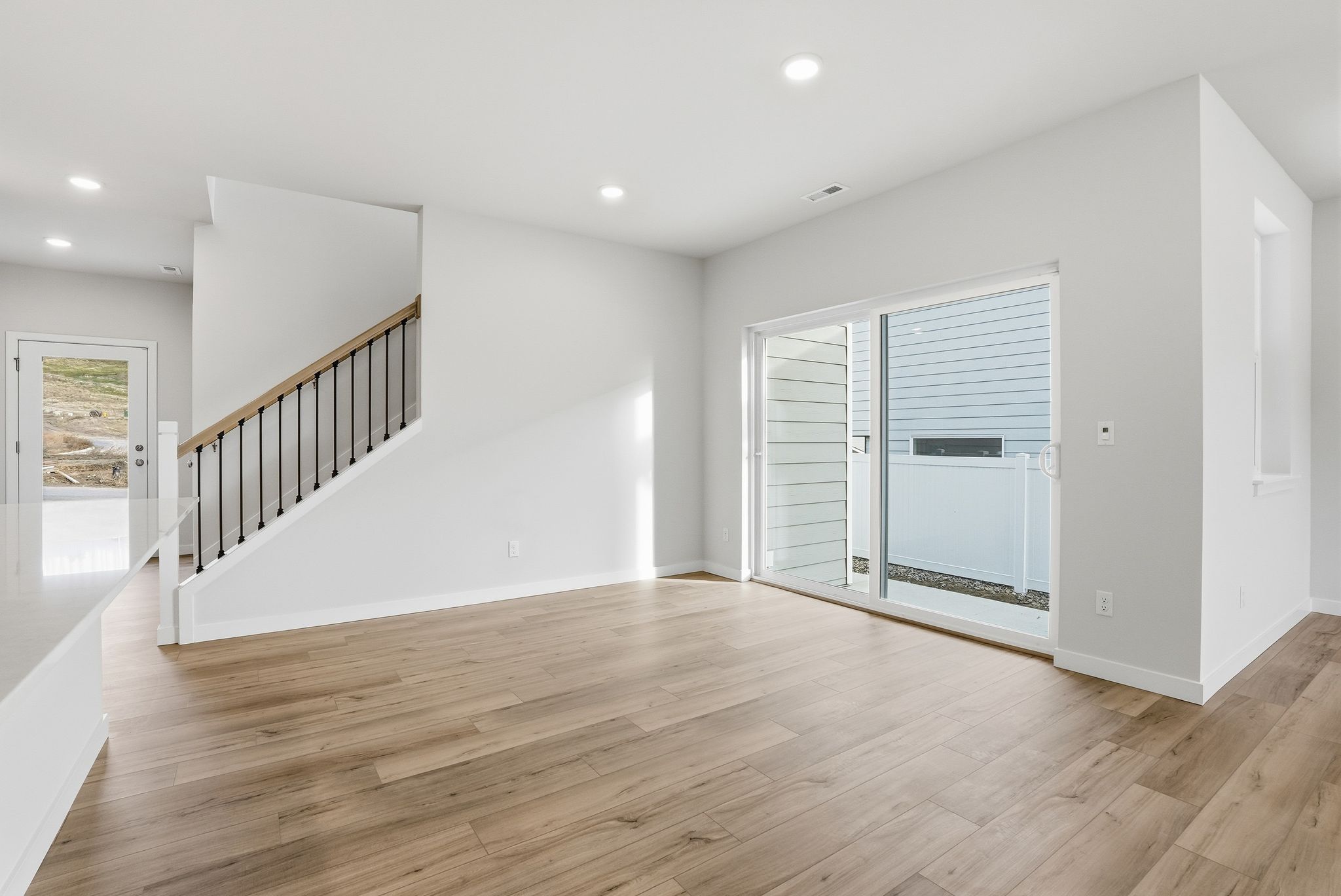 A room with white walls and wood floors.