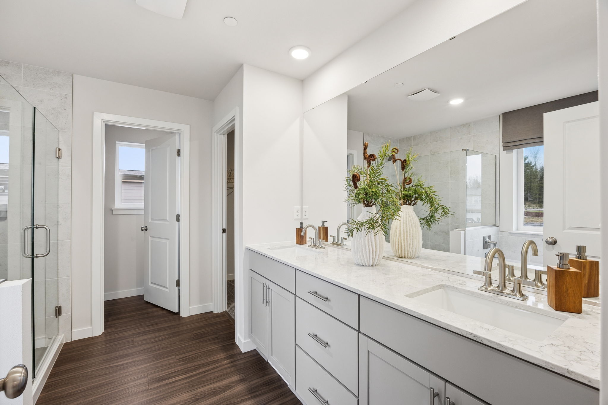 A bathroom with white cabinets.