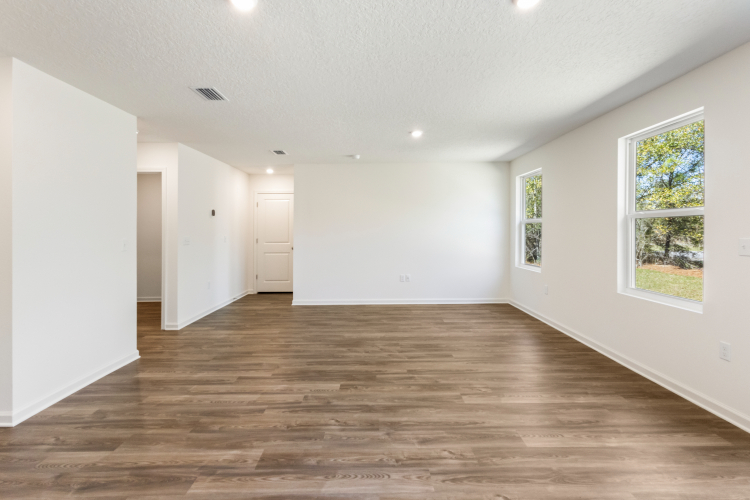 A room with white walls and a wood floor.