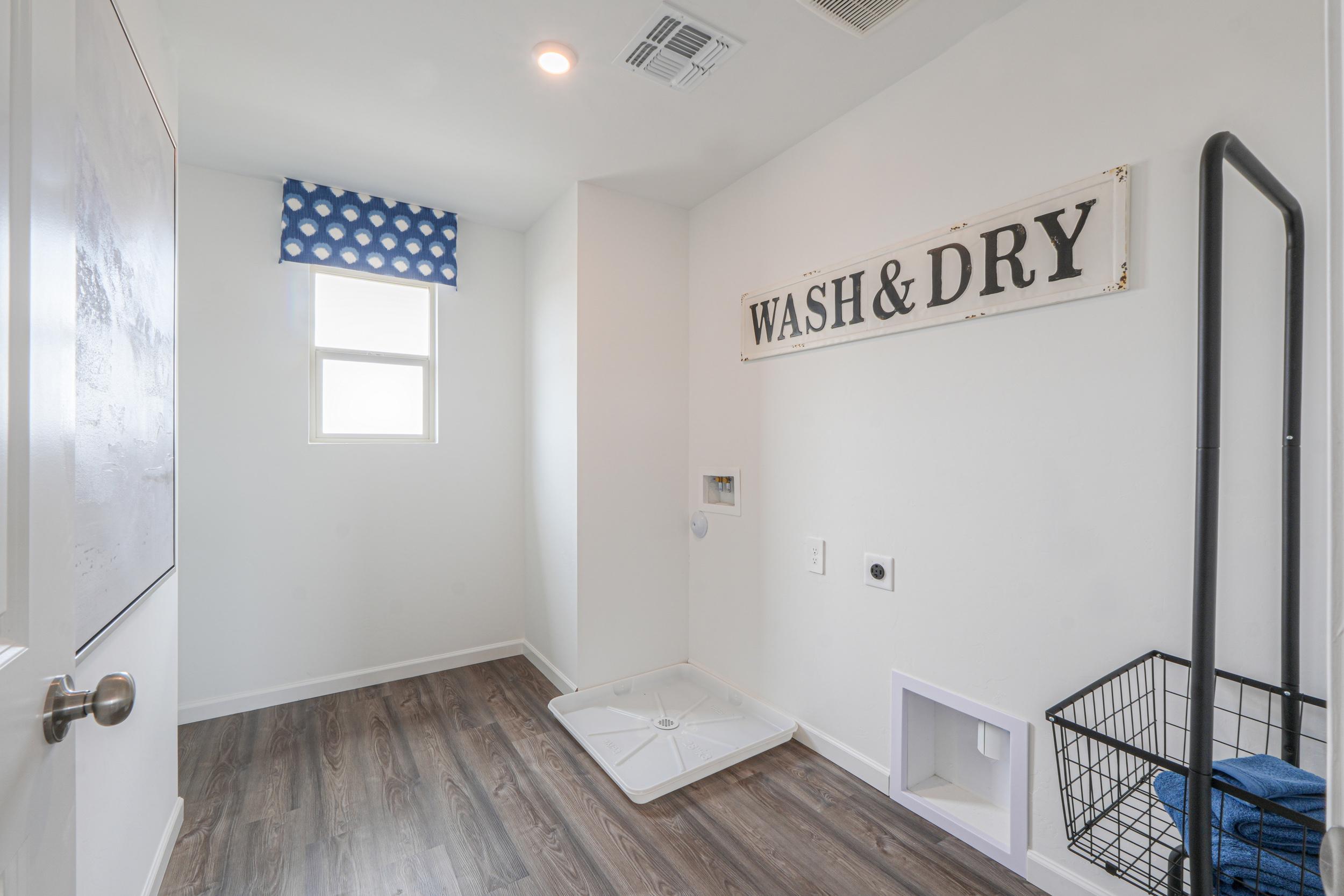 A room with a bathtub and a sign on the wall.