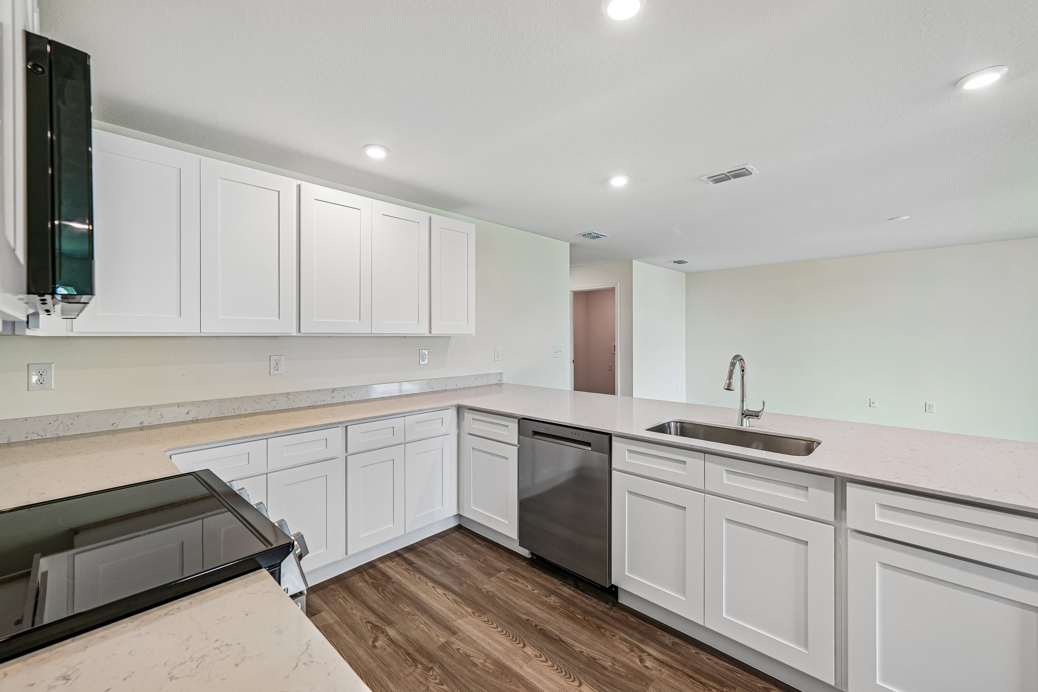 A kitchen with white cabinets.