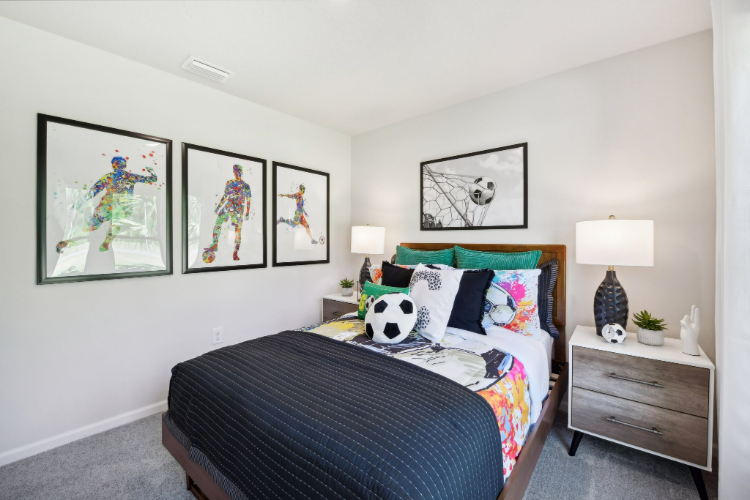 A bedroom with a bed and lamps.