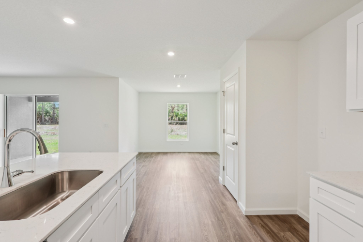 A kitchen with white cabinets.
