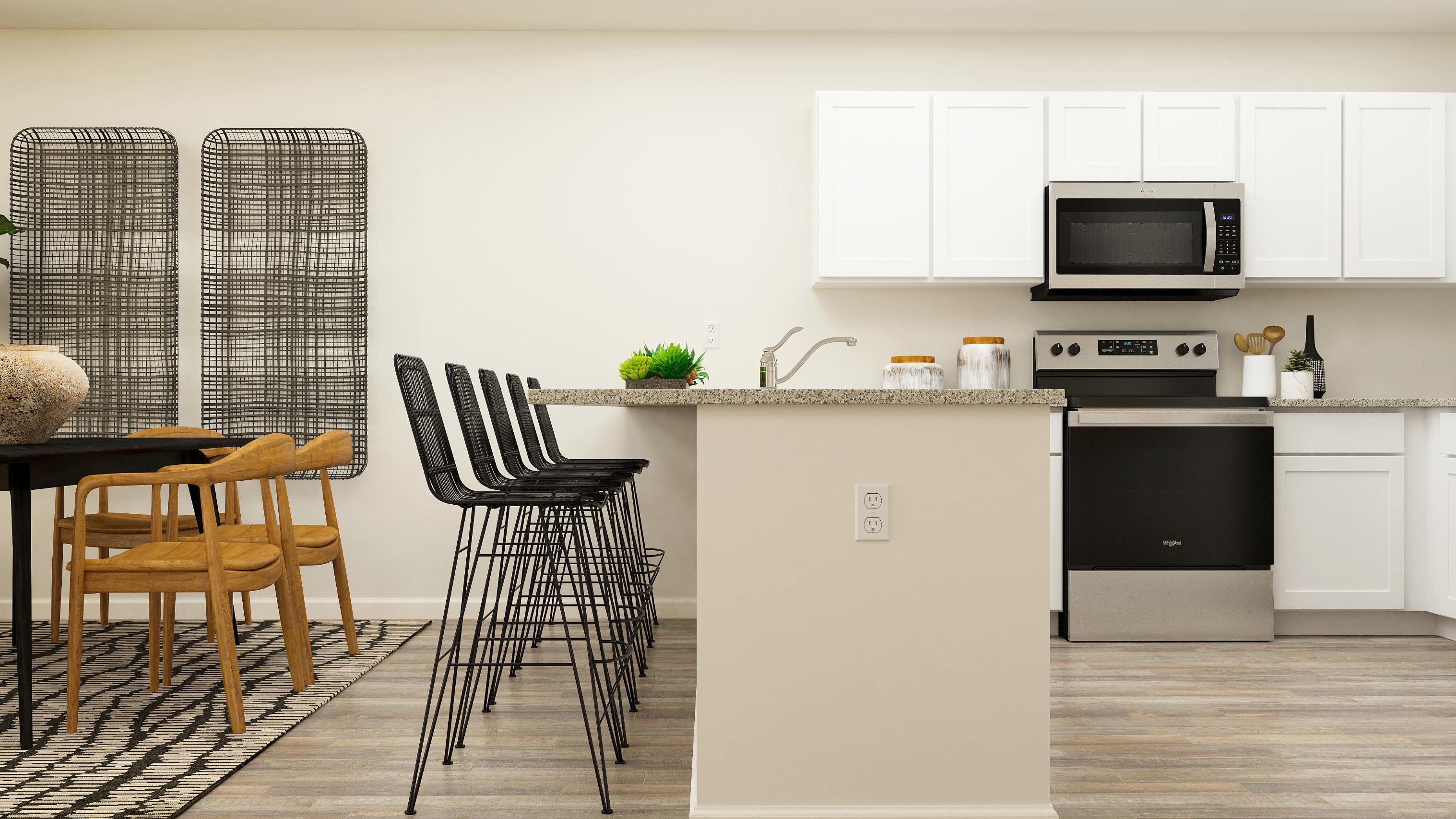 A kitchen with white cabinets.
