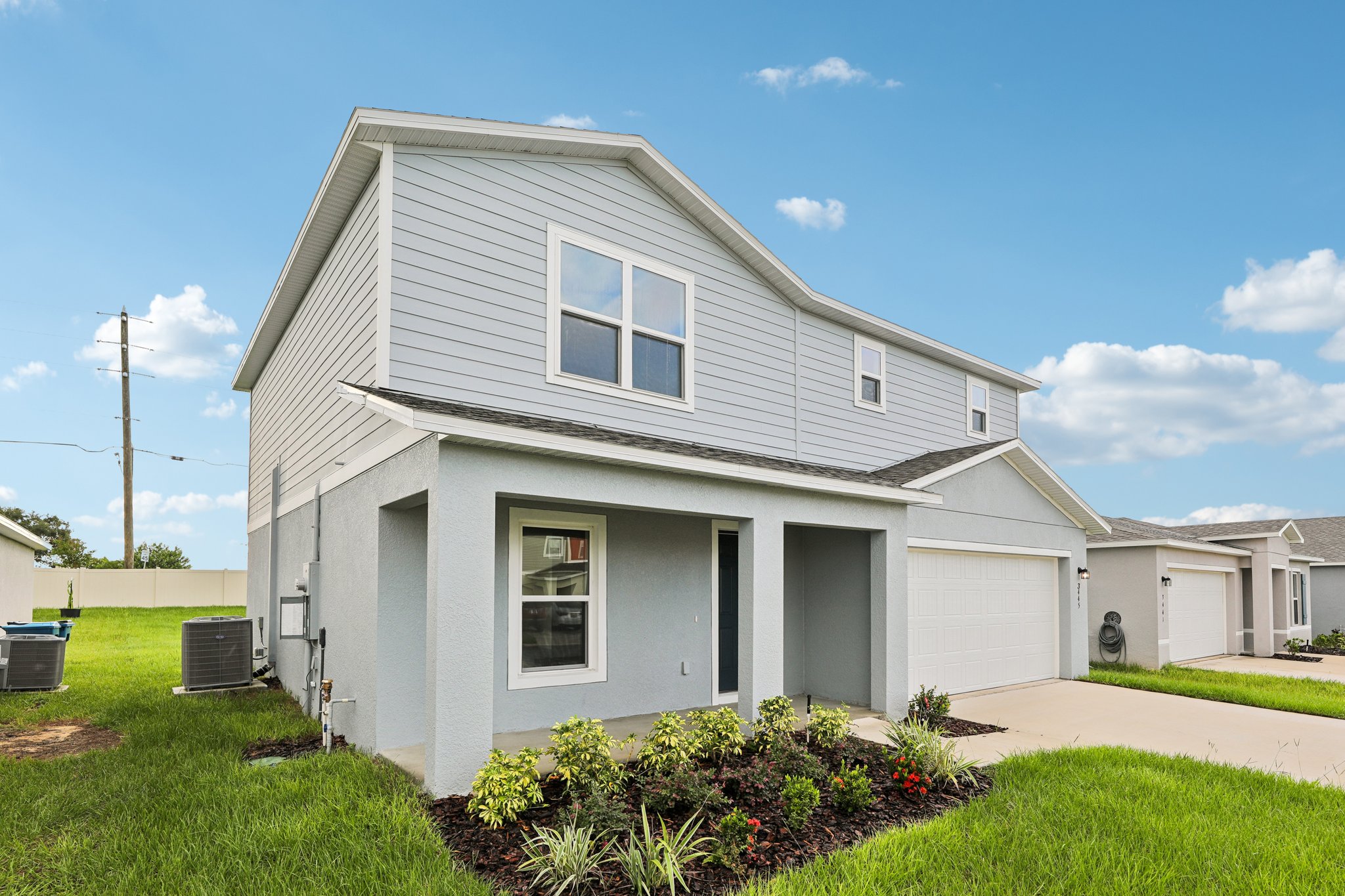 A white house with a driveway.