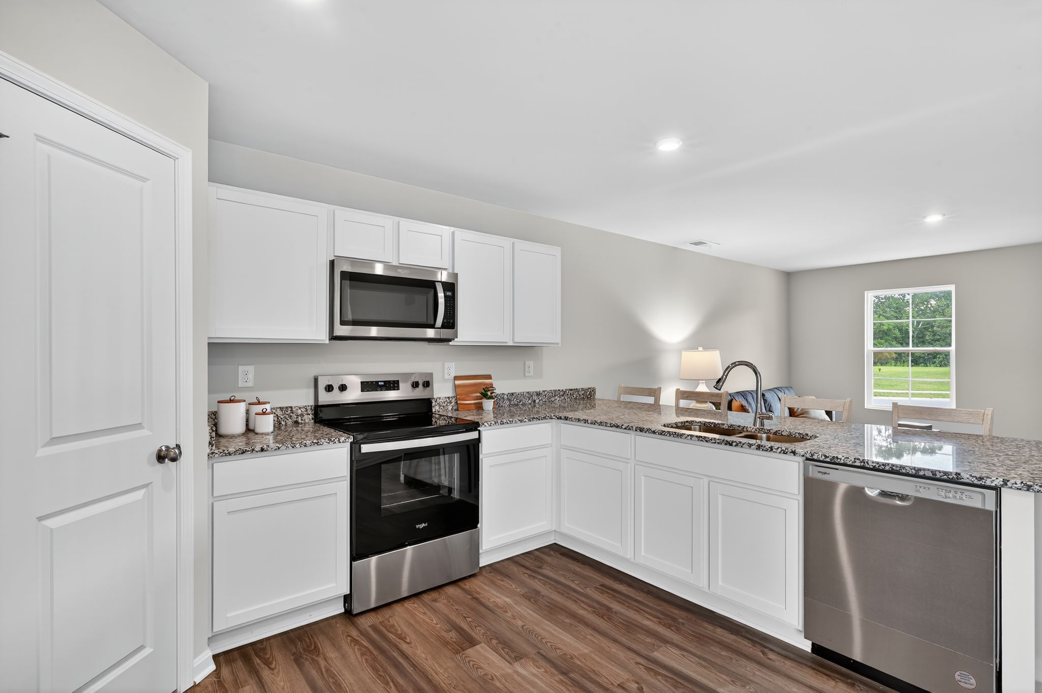A kitchen with white cabinets.