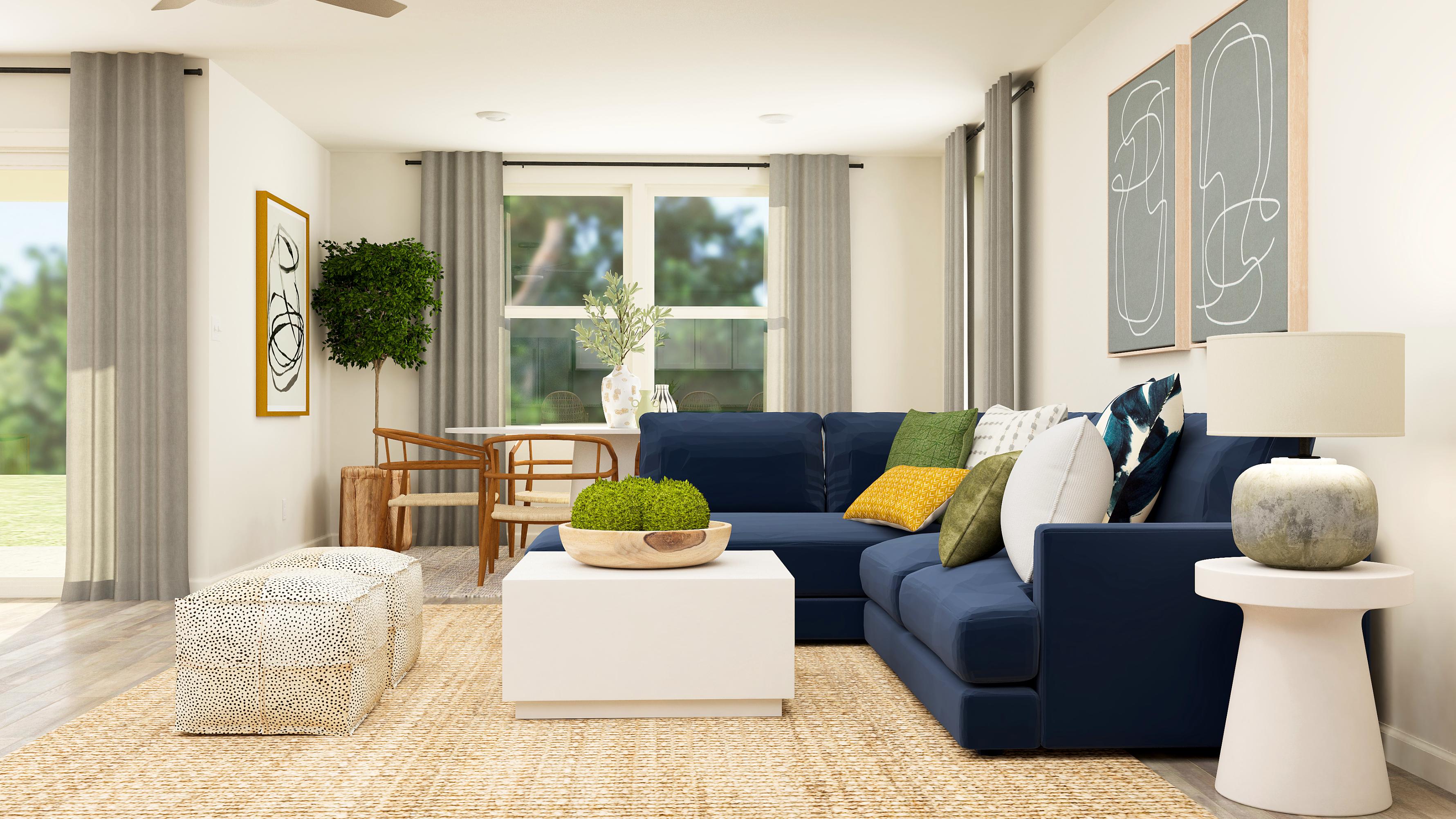 A living room with a blue couch and a table.
